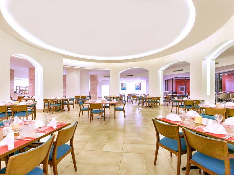 Elegant dining room with wooden tables and chairs at Pickalbatros Laguna Vista Hotel in South Sinai Governorate.