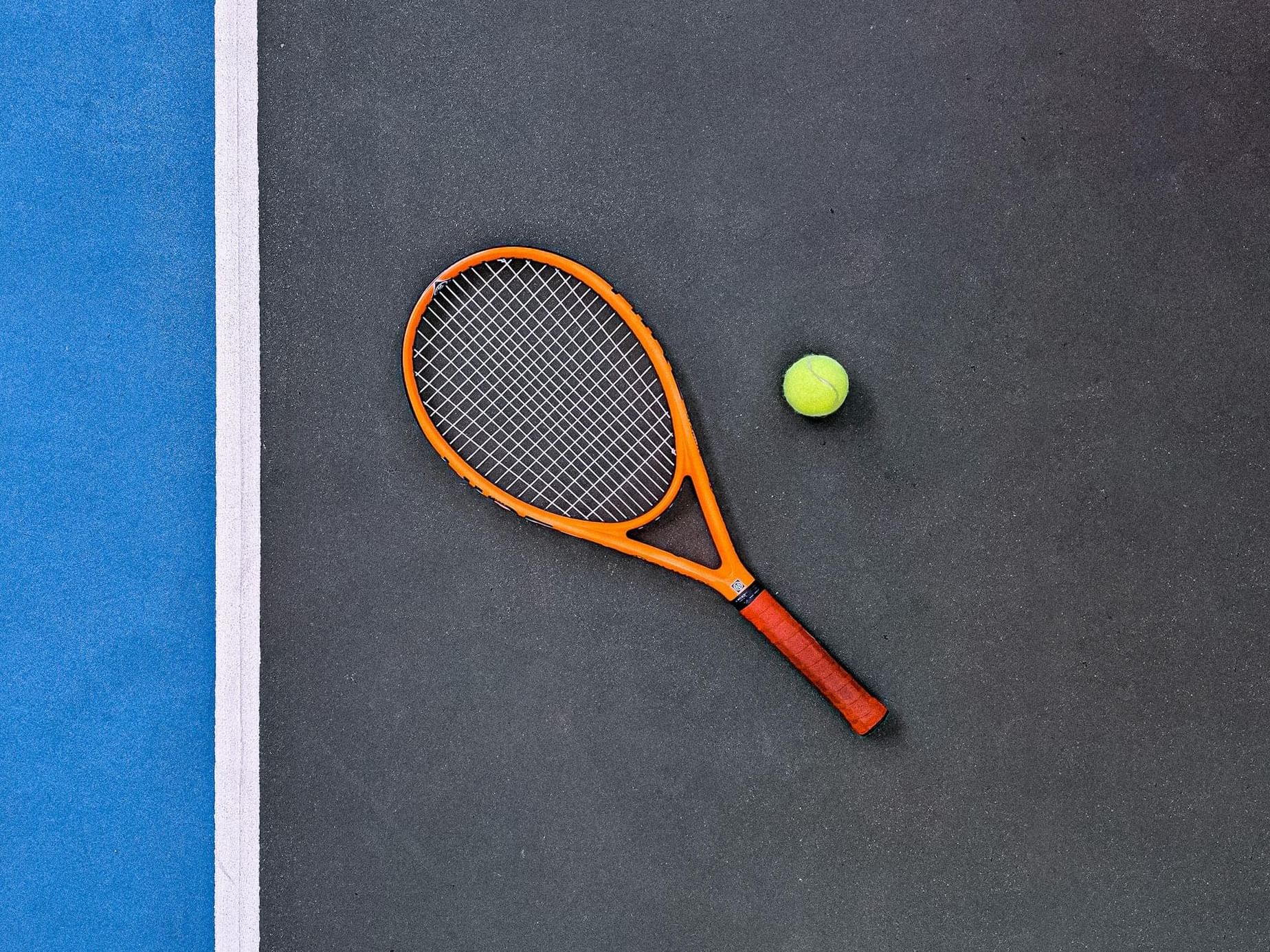 Tennis racket and ball on the court in Racquet Club at Ananea Madivaru Maldives