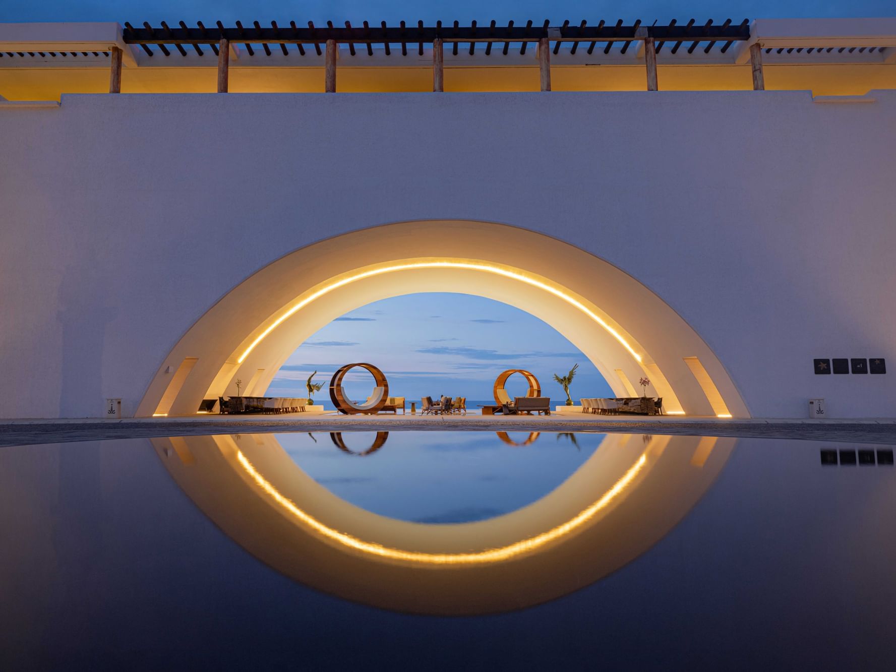 Modern lounge area by the pool overlooking the beach at Marquis Los Cabos