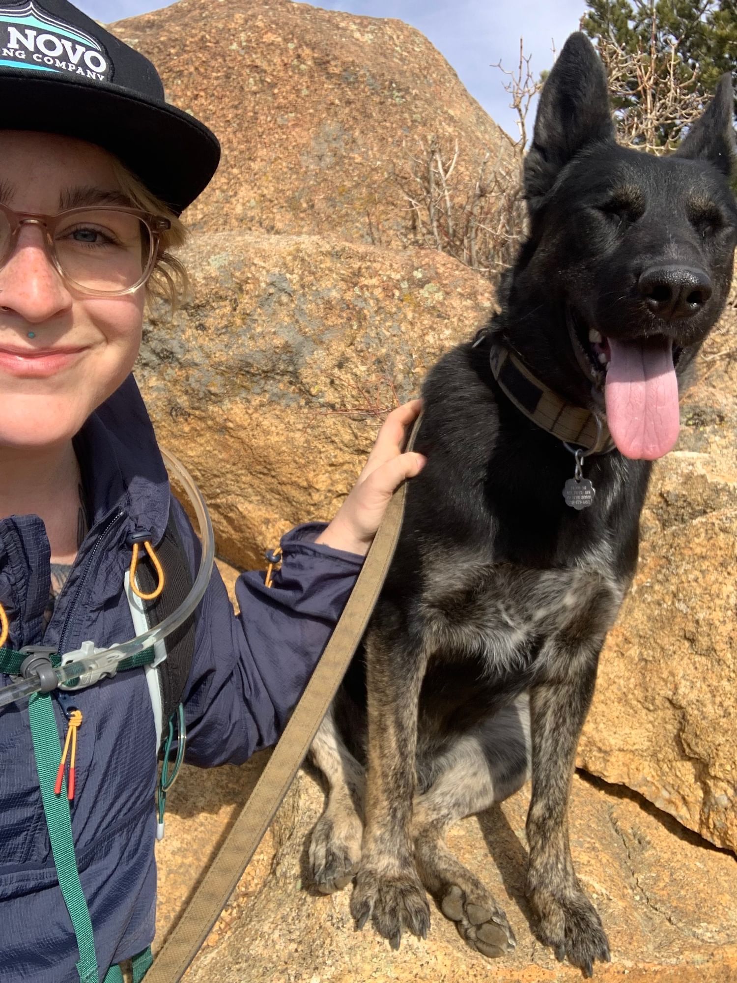 A man & a dog posing for a selfie while hiking, Kinship Landing