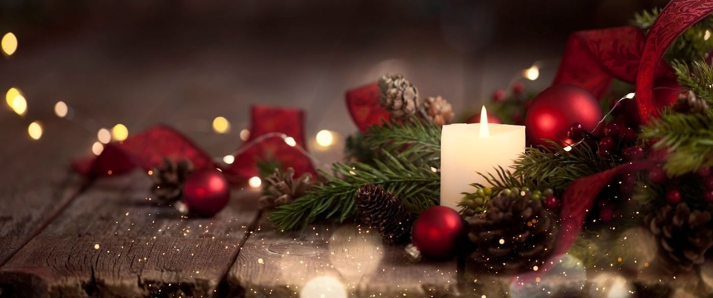 Close-up of a Christmas Day candle hamper adorned with golden sparkles in a festive setting at The Londoner Hotel