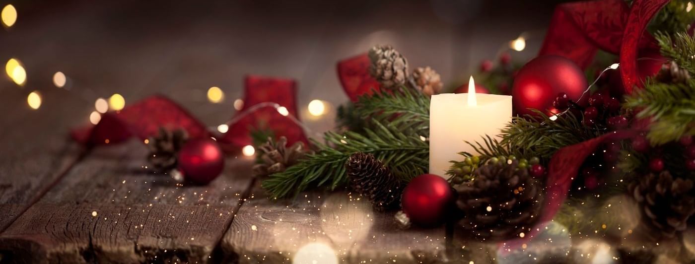 Close-up of a Christmas Day candle hamper adorned with golden sparkles in a festive setting at The Londoner Hotel