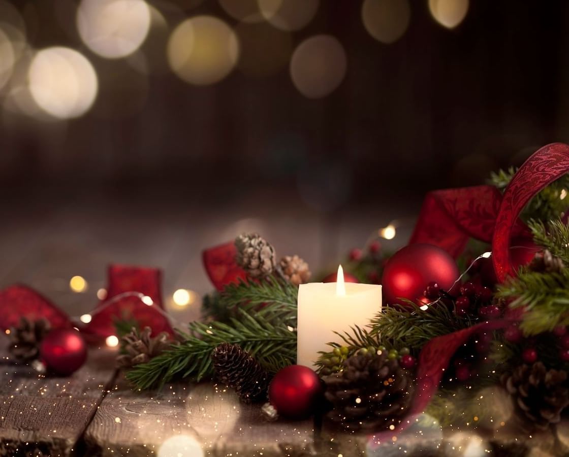 Close-up of a Christmas Day candle hamper adorned with golden sparkles in a festive setting at The Londoner Hotel