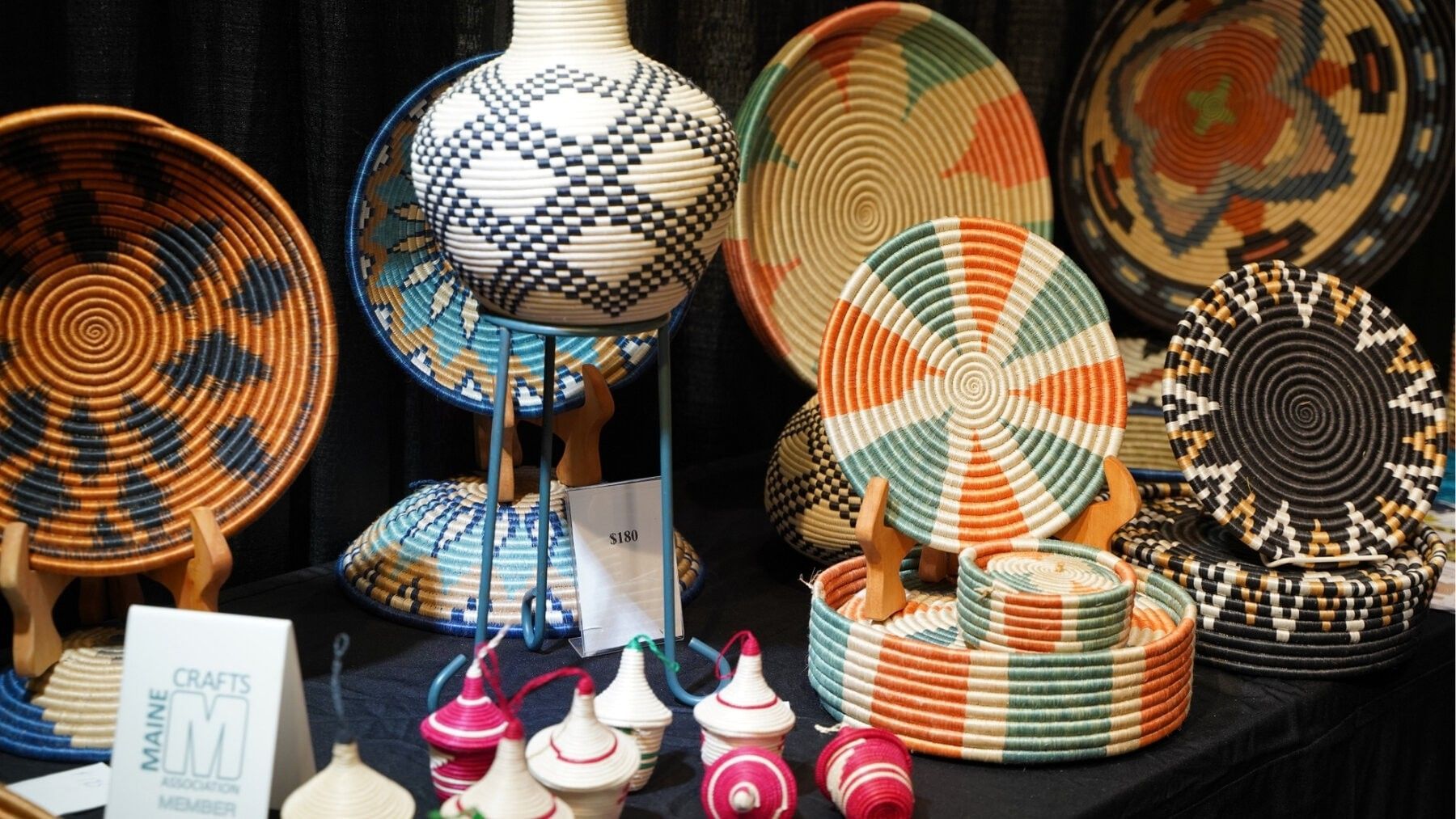 Display of colorful woven crafts at the Palm Beach Fine Craft Show.