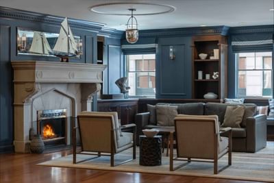 Fireplace by the lobby lounge area with wooden floors at Portland Harbor Hotel