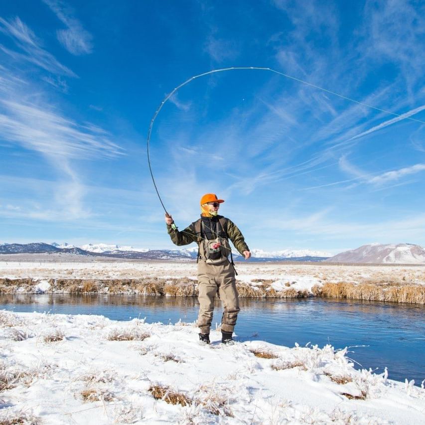 A man fishing in Mammoth Lake near Alpenhof Lodge