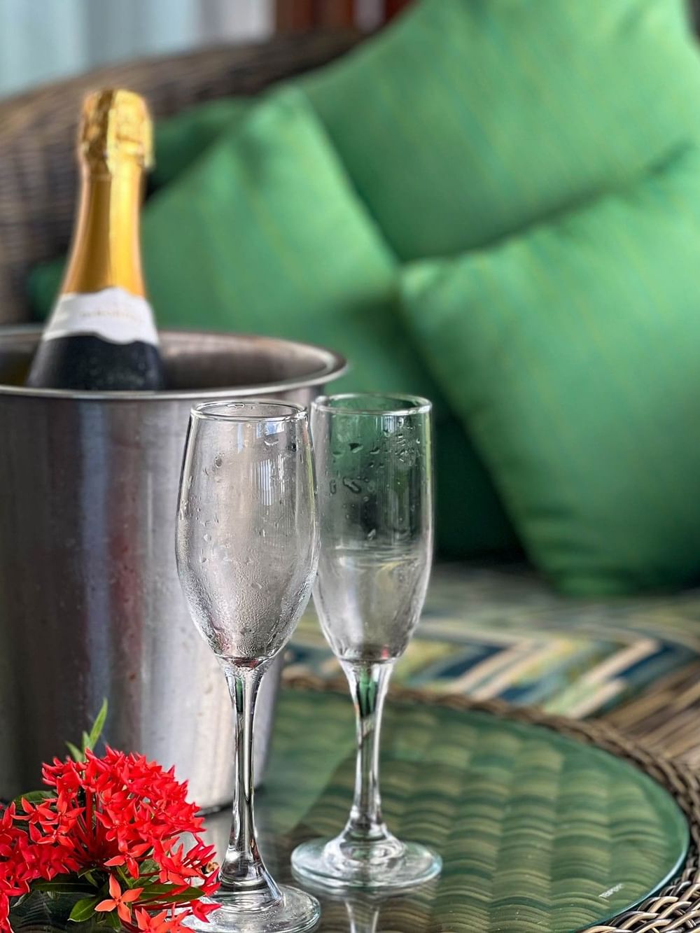 Champagne and glasses in bucket on wicker table in one-bedroom villa at The Naviti Resort Korolevu.