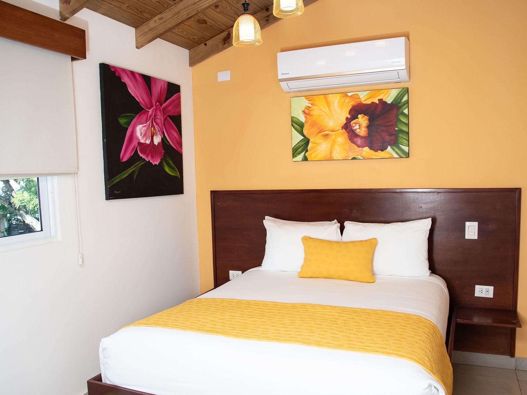 Master Room with a queen bed and paintings at Villas Codevi