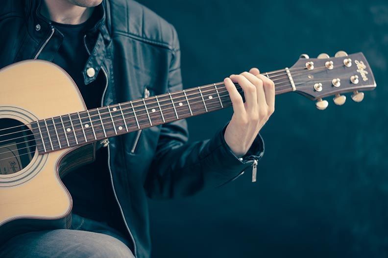 Close-up of a man holding a guitar at Mission Inn Riverside