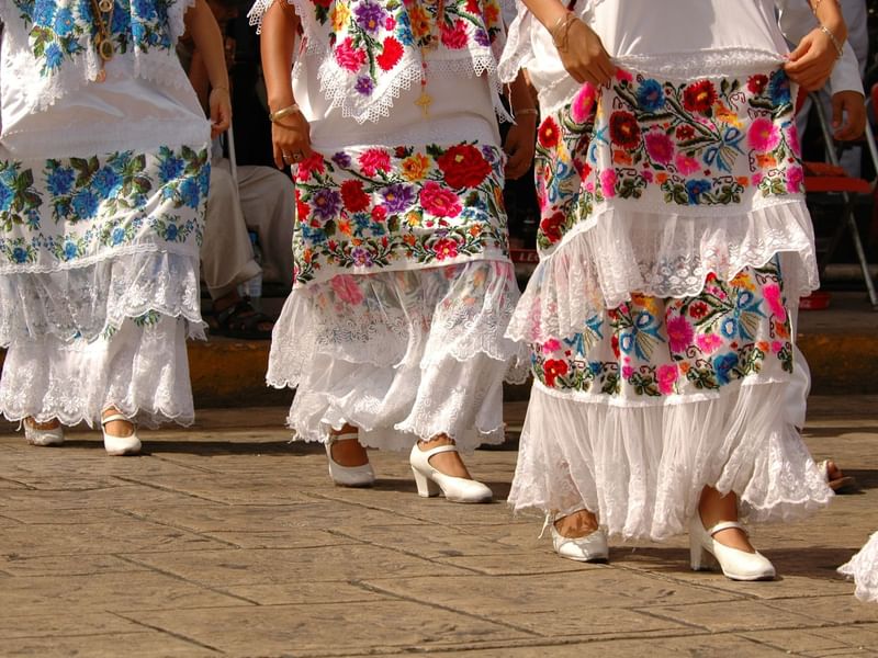 Women walking in traditional clothes while at Fiesta Americana