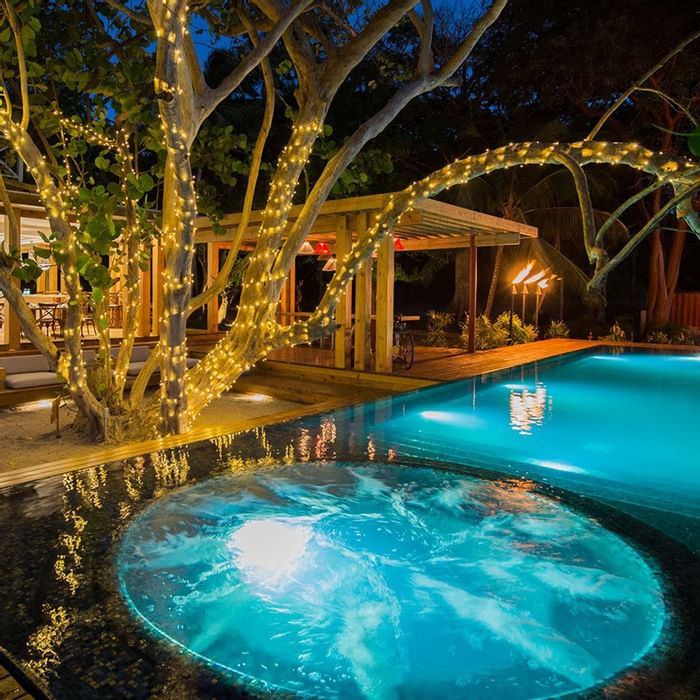 An outdoor jacuzzi at night in Ibagari Boutique Hotel