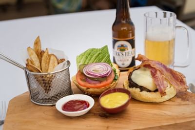 Snacks with sauce served with beer glass in a restaurant at Windsong Resort On The Reef
