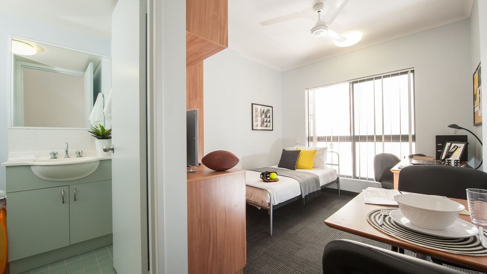 Modern studio apartment with single bed, dining area, kitchenette, and bathroom at StudentLiving - on Margaret