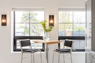 Table & 2 chairs by a window in Apartment 199B at Retro Hotel