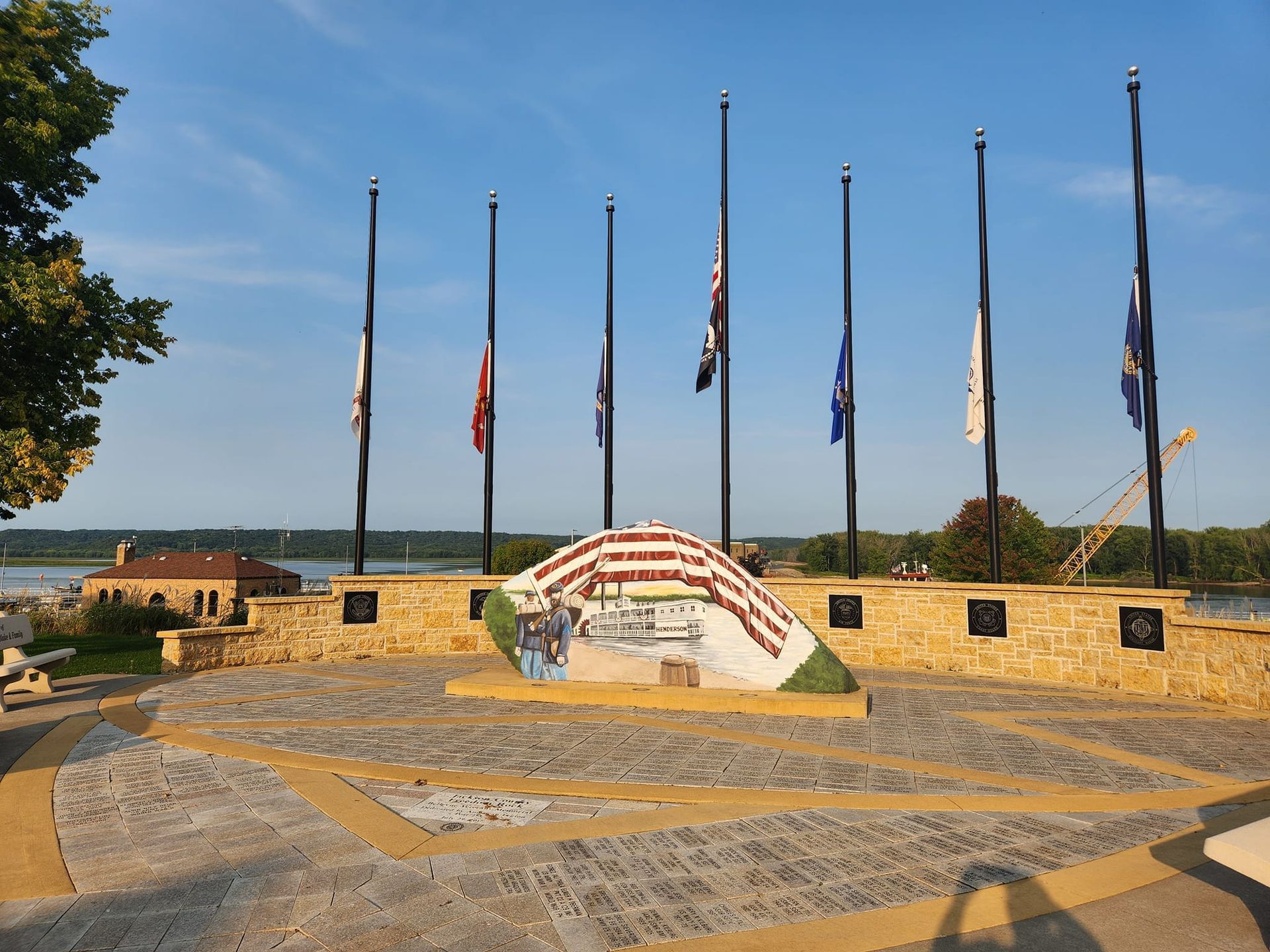 A monument with flags and a statue of a man in Freedom Rock near Off Shore Resort