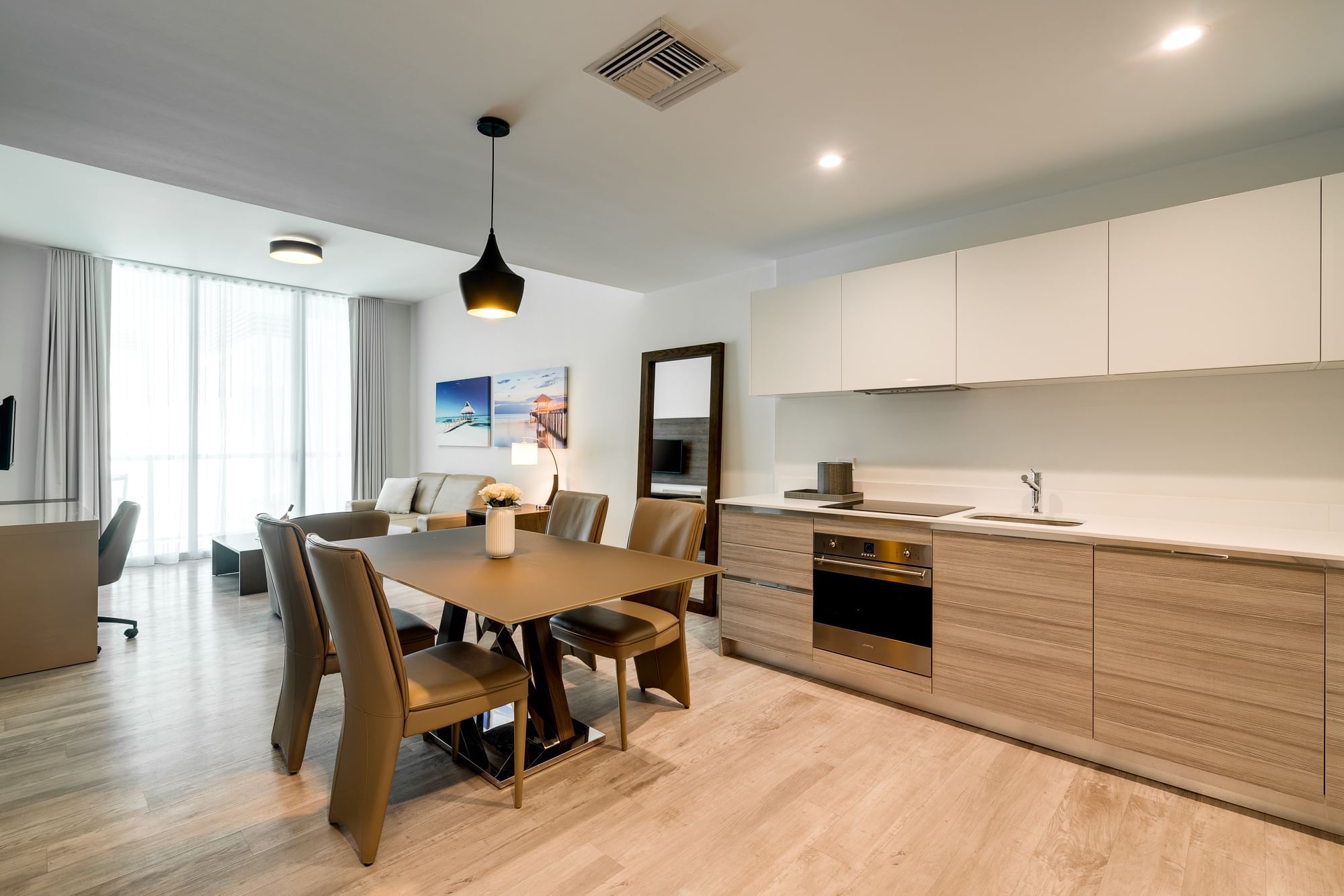 A modern open-plan living space with a kitchen, dining area, and living room.
