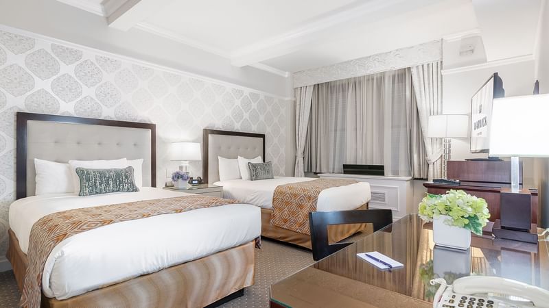 Bedside cupboard, TV & work desk by the beds in Premier Room at Warwick New York