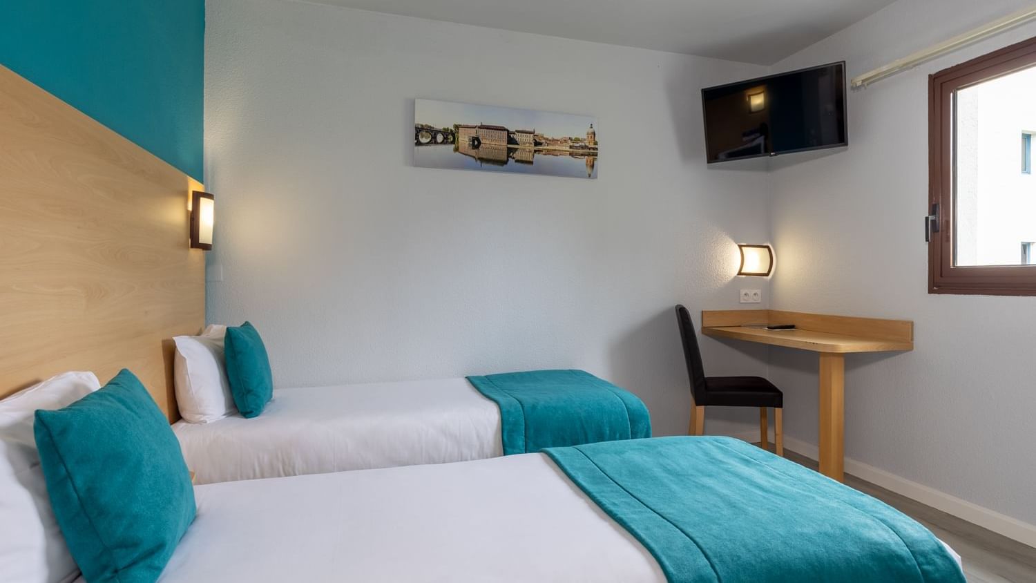 Twin beds with white & blue bedding at Originals Hotels