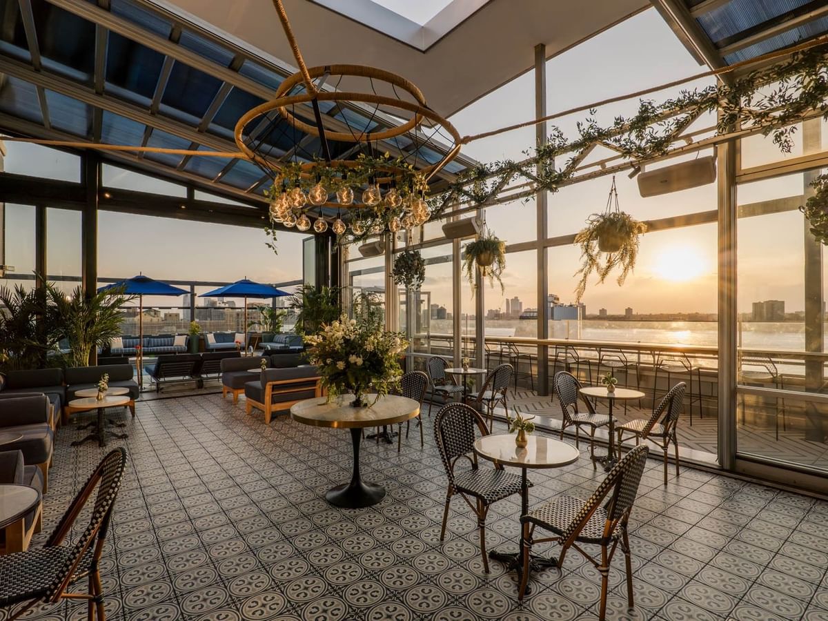 Eden at Gansevoort Rooftop features elegant seating, hanging greenery, and sunset river views at Gansevoort Meatpacking NYC.
