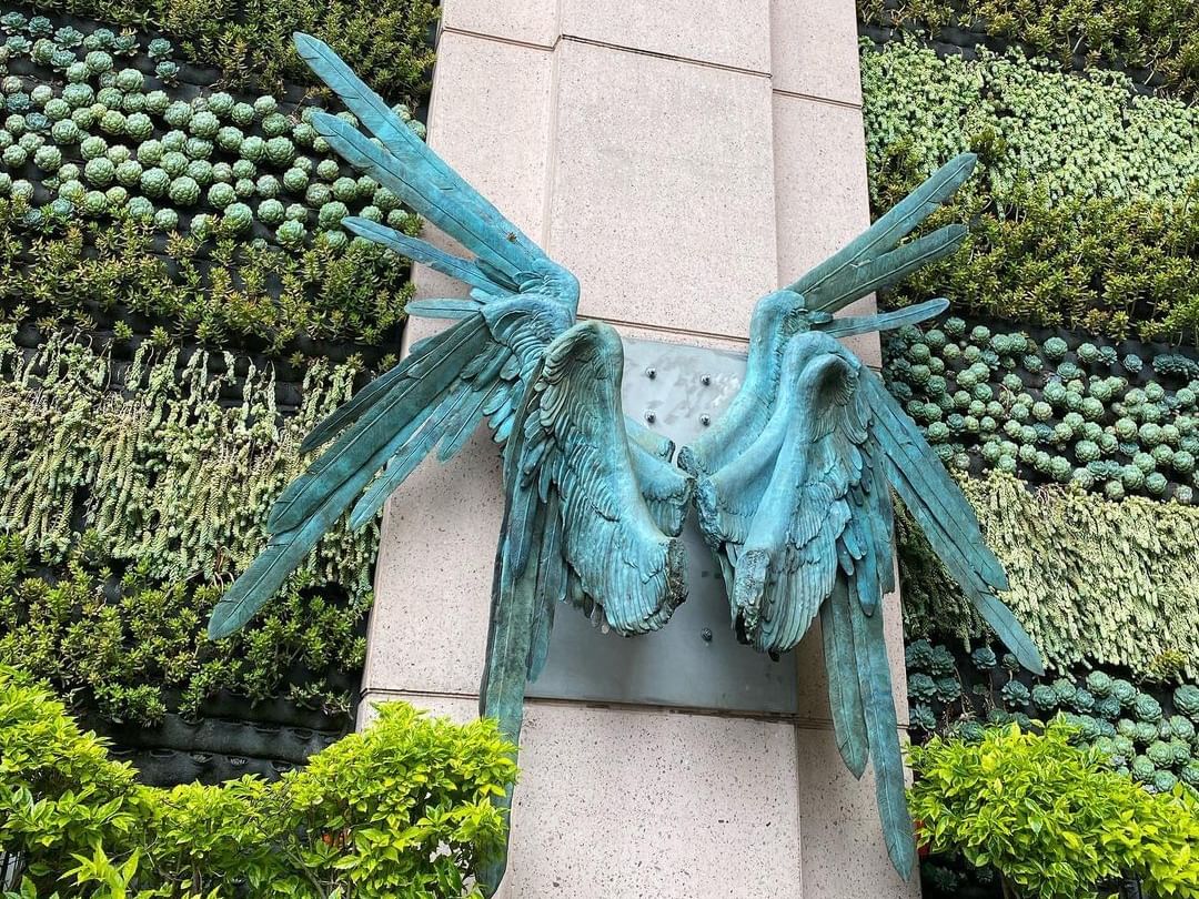Angel wings décor hanging on a wall at Marquis Reforma