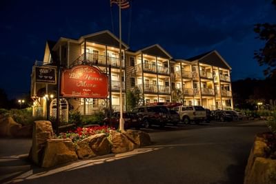 exterior of Bar Harbor Manor at night with lights from roons on