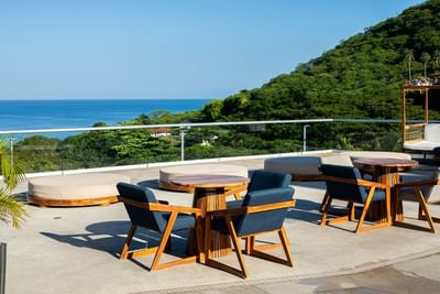 Dining tables arranged on a balcony in Bahía Restaurant at Villas Sol Beach Resort