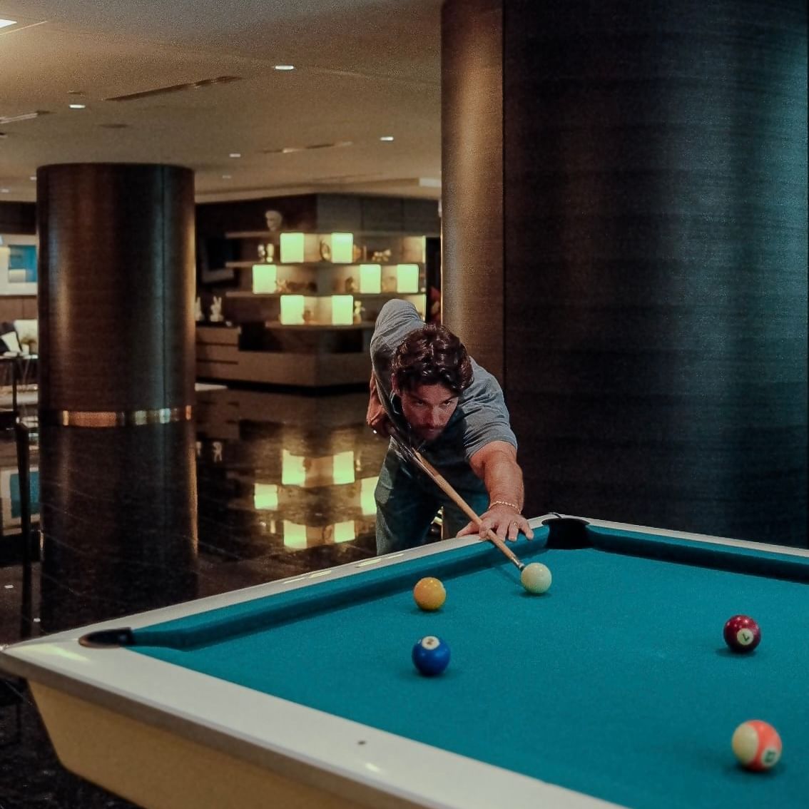 Joe Scarpellino playing pool at the lounge of the Paradox Hotel in Vancouver.