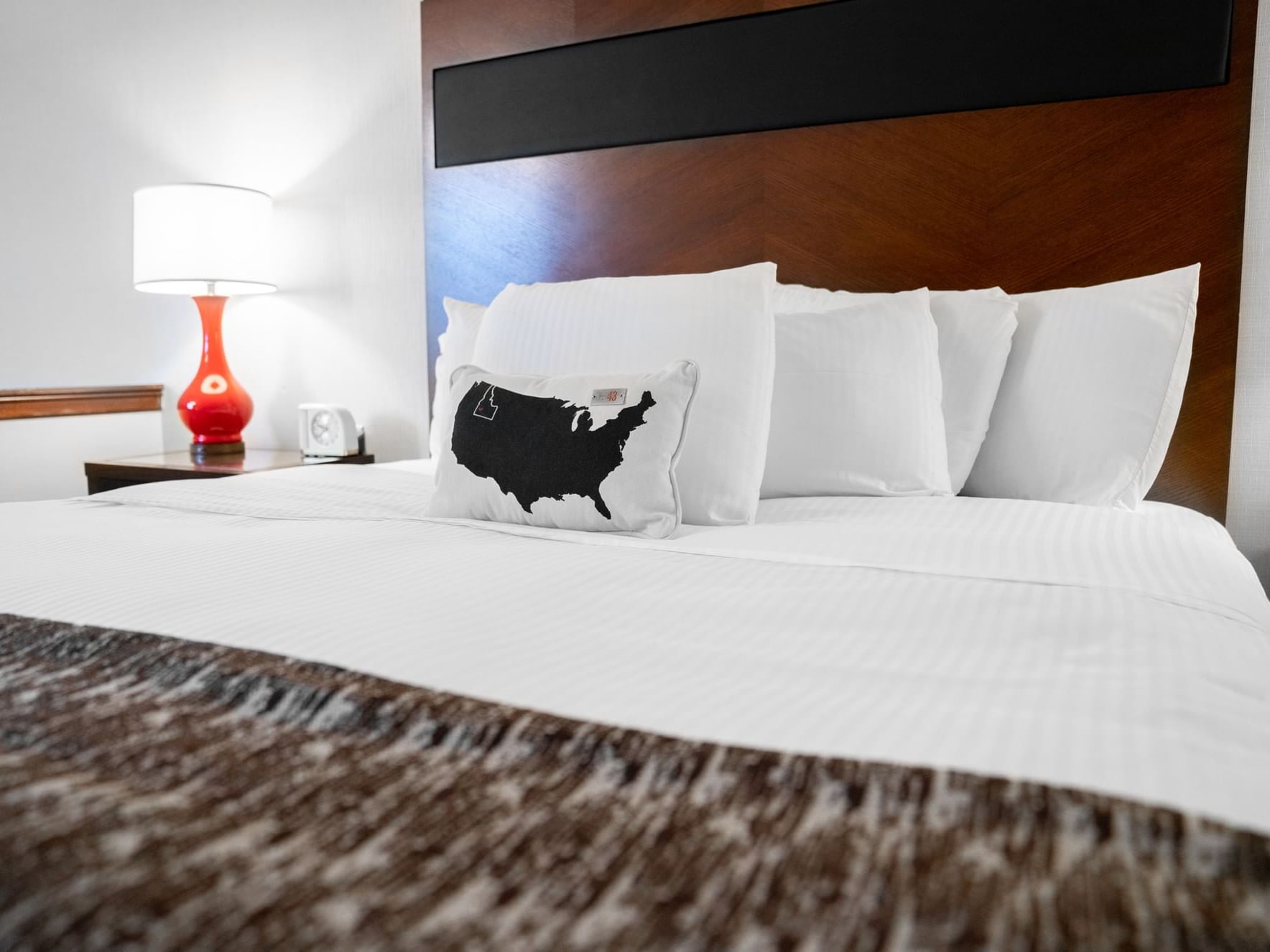 King bed with pillows & table lamp in a room at Hotel 43