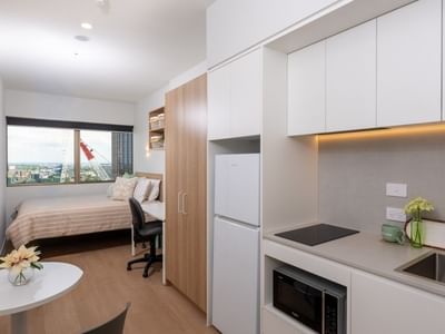 Studio apartment with kitchenette and bedroom at UniLodge Brisbane City.