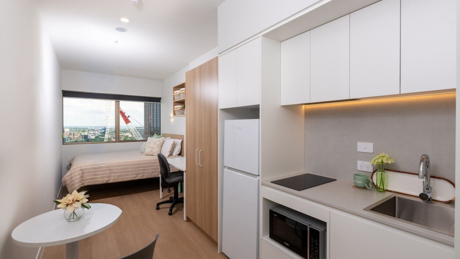 Studio apartment with kitchenette and bedroom at UniLodge Brisbane City.