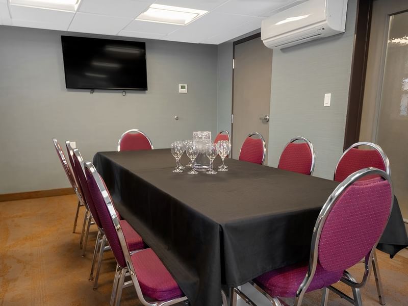 Coast Calgary Downtown Hotel & Suites by APA meeting room with chair, table, air condition, and TV