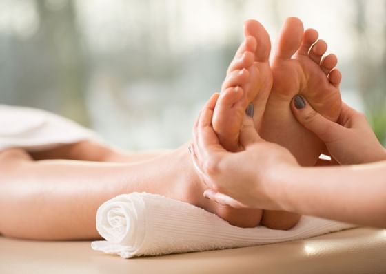 Close-up of reflexology session for woman at Honor's Haven Retreat