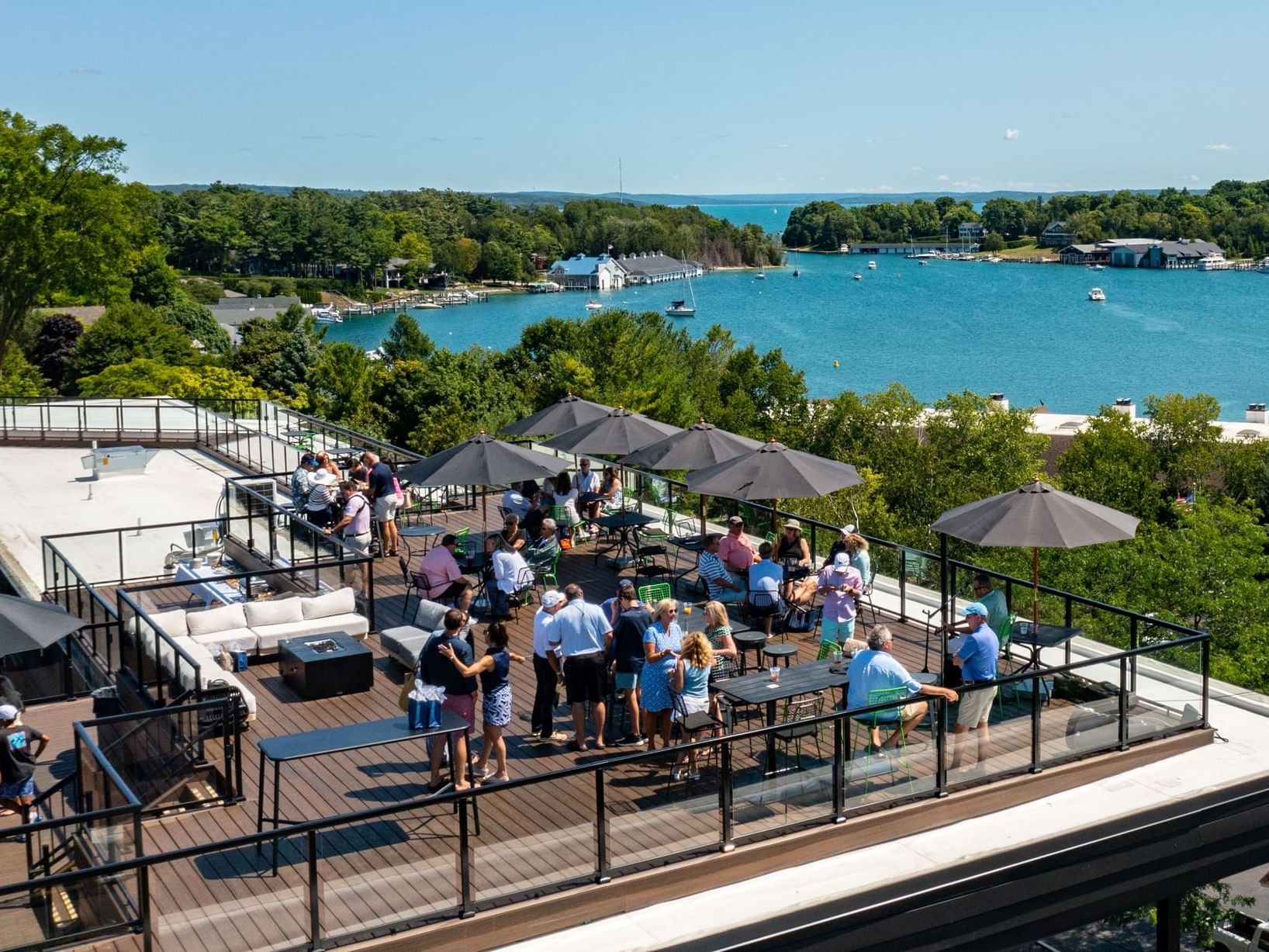 People hanging out on the rooftop lounge area with a sea view in HI Bar at The Earl