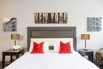 Comfy bed, pillows & bedside tables with lamps in King Superior Manhattan at Retro Suites Hotel