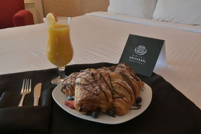 Breakfast pastries and glass of orange juice.
