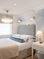 Elegantly decorated penthouse bedroom with a king-size bed at The Capital Hotel, Apartments & Townhouse
