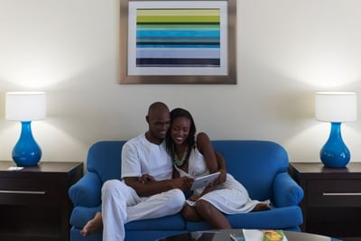 A couple cuddling up on a sofa at Holiday Inn Montego Bay