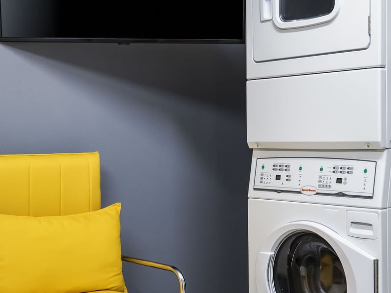 Washing machine & lounge in a laundry room at Fiesta Inn Hotels
