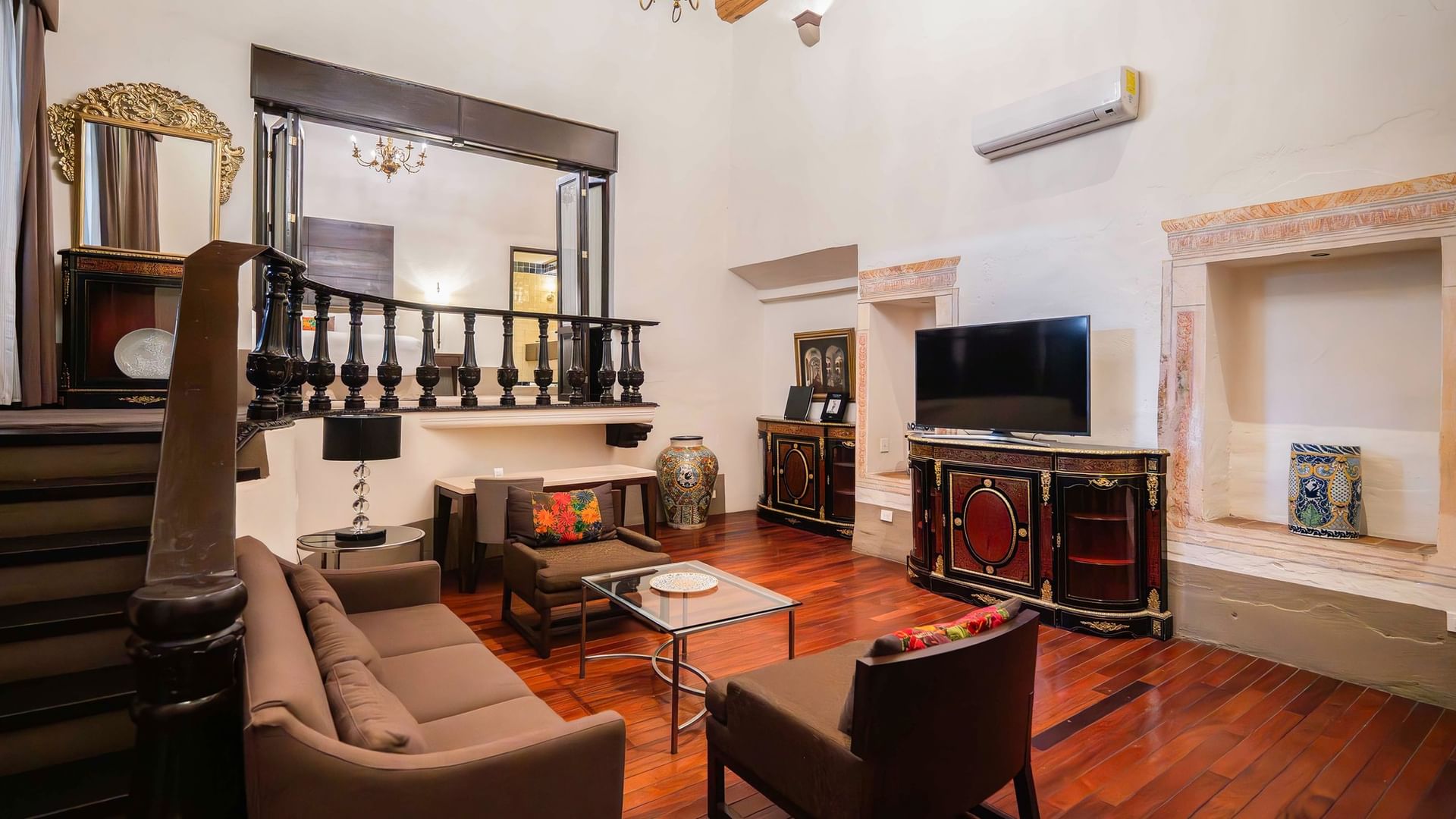 Sala de la Suite Presidencial King con muebles elegantes y TV en Quinta Real Puebla en Heroica Puebla de Zaragoza