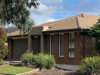 Brick house with brown roof and green garden at La Trobe University Regional Housing.