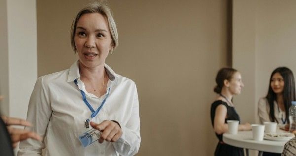 Businesswoman networking at corporate event with name tag
