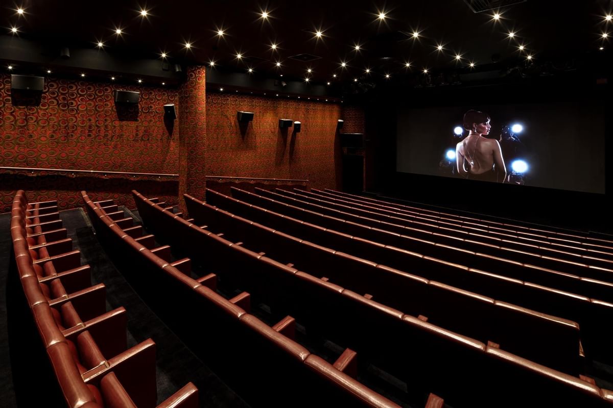 Interior of May Fair Theatre with rows of seats facing a large screen at The May Fair Hotel, London