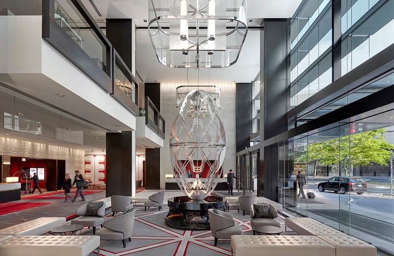 Modern interior of lobby with artistic chandelier, sleek furniture featuring Relax at Crown Hotels