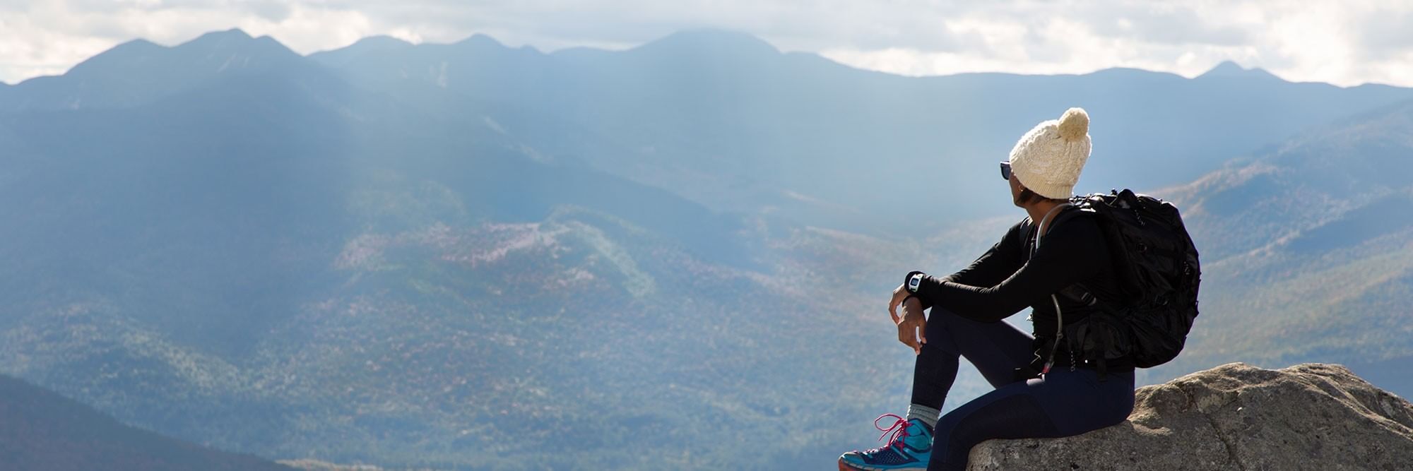 Women looking at Adirondack Mountain range.