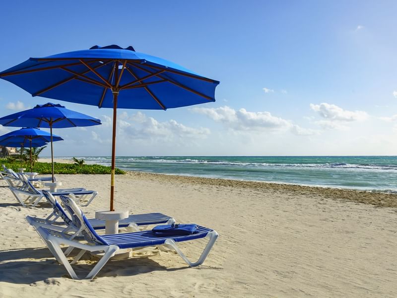 Beach chair with umbrellas on the beach at The Reef Playacar