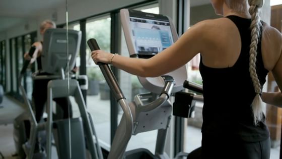 Lady doing cardio on an exercise bike, Fitness Centre, The Nest