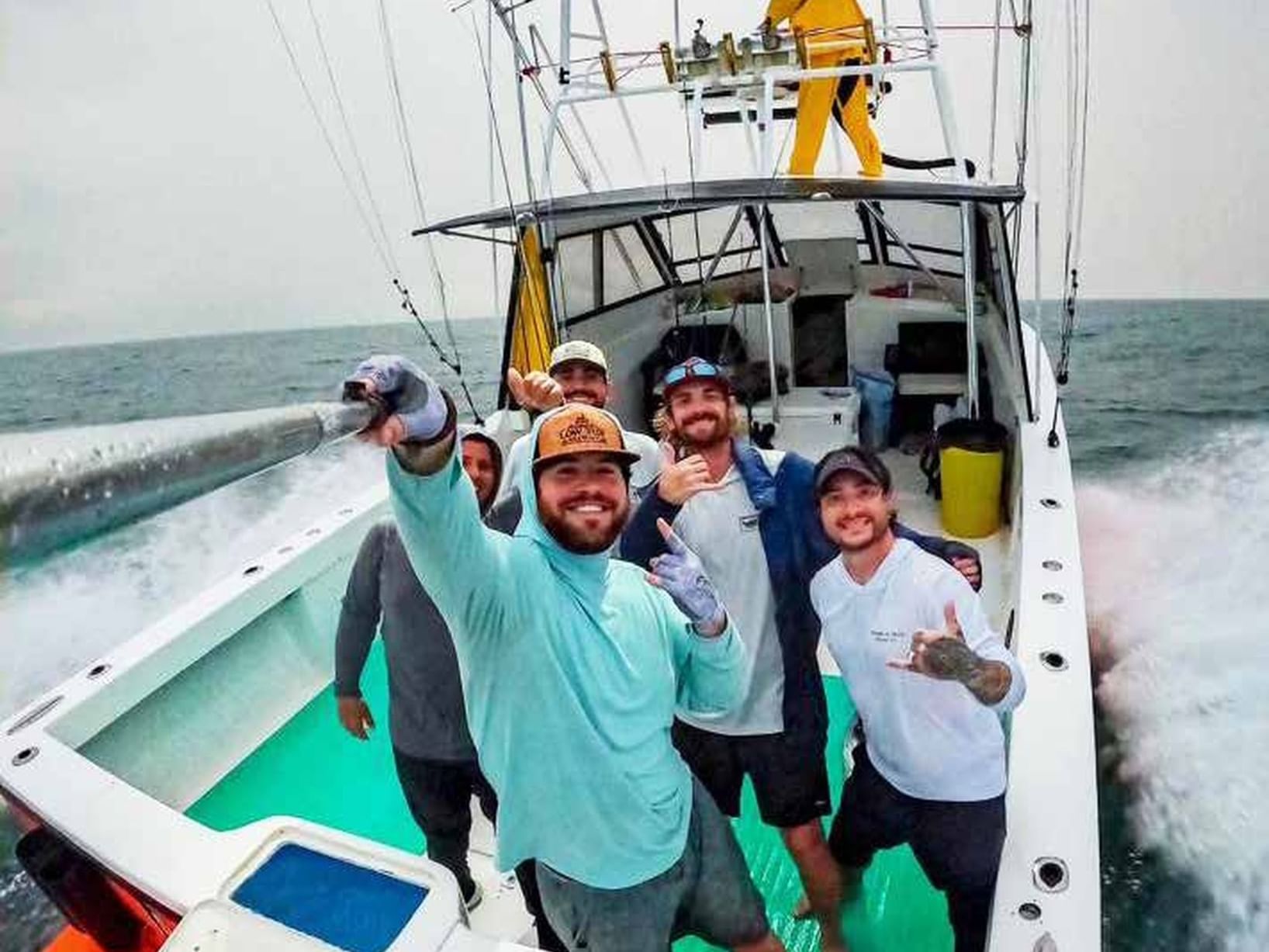 Group of people posing in boat, Golfo Dulce, Playa Cativo Lodge