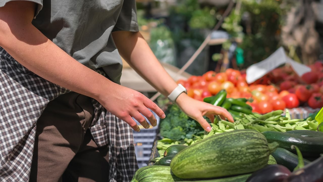 shoppers picking fresh vegetables at a local farmers market