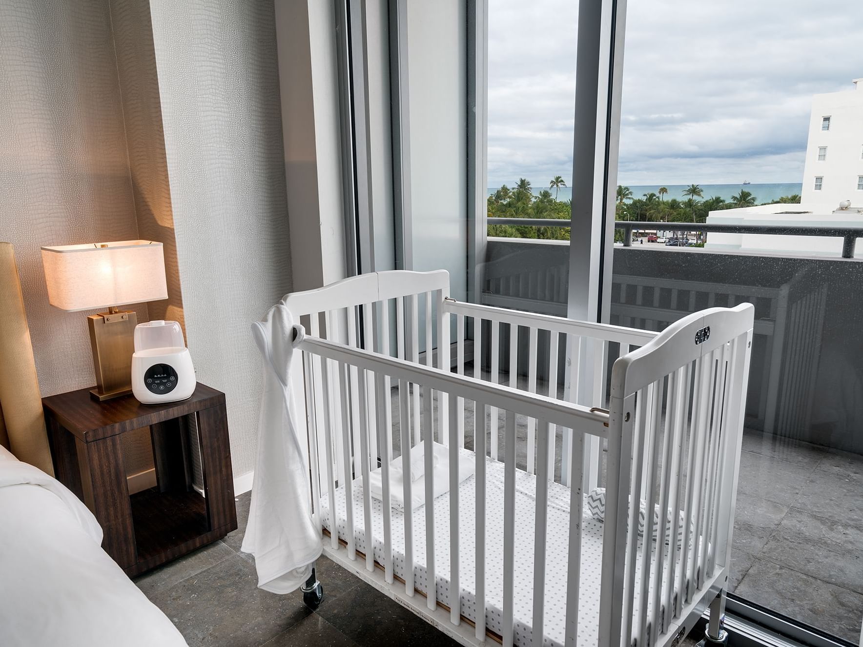 A crib near bed in bedroom at Boulan South Beach Hotel