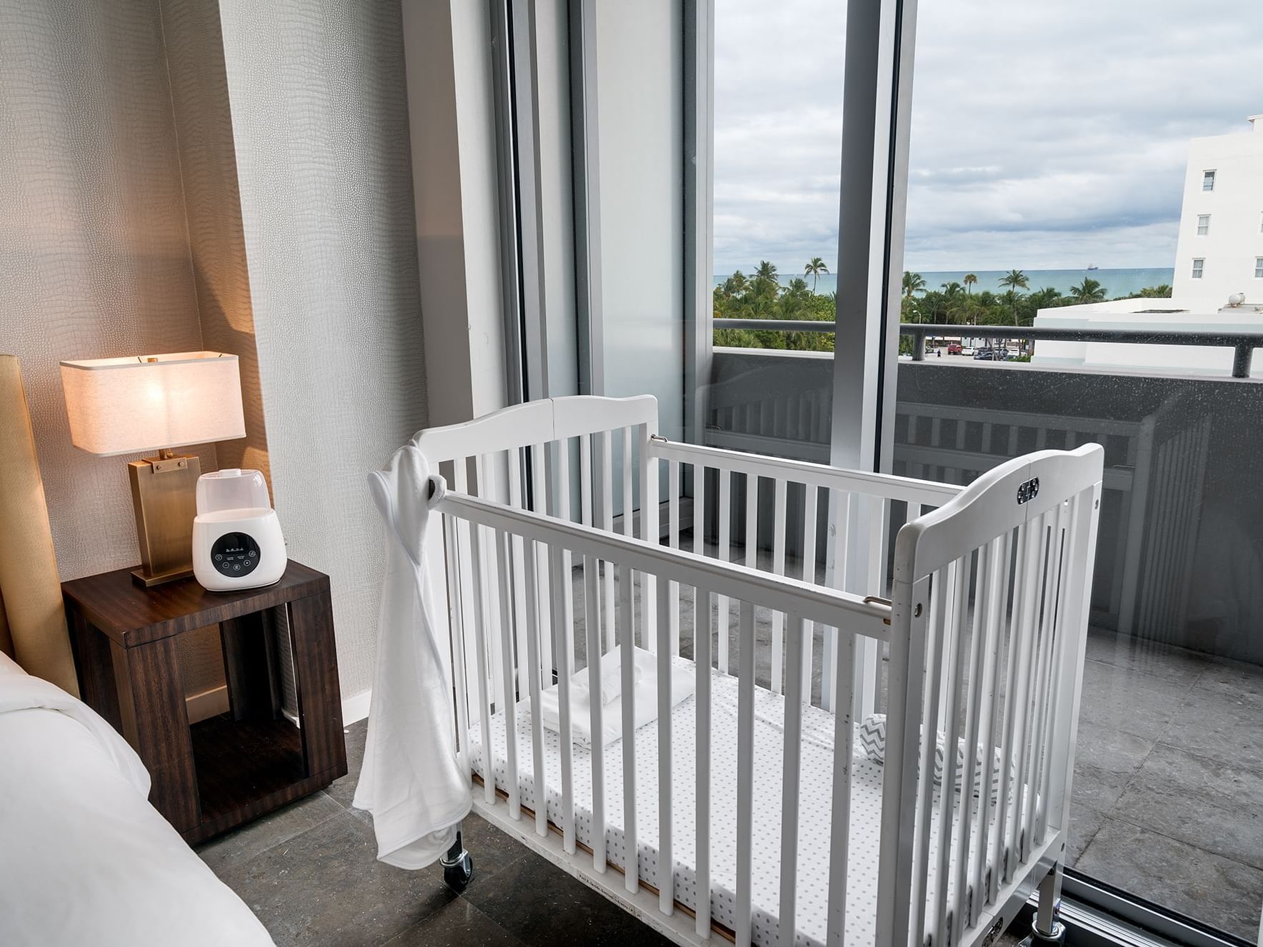 crib near bed in bedroom